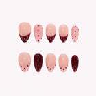 Retro Wine Reverie: pink and burgundy almond press-on nails with dark polka dots and French tips, arranged on a pale background.