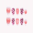 Cupid’s Crystal Bow: pink almond press-on nails with leopard spots, soft ombre and translucent bows, arranged on a pale background.