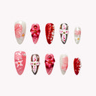Sakura Chrome Odyssey: red, pink and white almond press-on nails with raised flowers and metallic decorations, set arranged on a pale background.