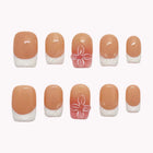 Gardenia Glass French short square nude nails with white French tips and pink floral accent nails.