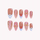 Freya’s Blossom Charm: pink almond press-on nails with blue French tips and small colorful flowers, arranged on a pale background.