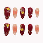 Empress's Crimson Mariposa burgundy and peach almond nails with yellow butterflies, gold-colored curves and tiny accents.