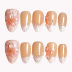 Calista's Quartz Bloom peach nude almond nails with translucent pale tips, raised pink flowers and pearly accents.