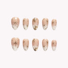 Astral Butterfly Veil: nude and white almond press-on nails with fine starbursts and gold-tone accents, set arranged on a pale background.
