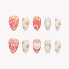 Sweetheart’s Pearl Aria: pink and white almond press-on nails with bows, raised hearts and pearl-like bead accents, set arranged on a pale background.