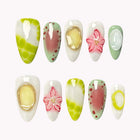 Kiwi Splash Sorbet almond nails with lime-green marbling, pink flowers, watermelon-like patterns and raised oval accents.