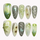 Veridian Nymph Wings almond nails in green, ivory and smoky gray with butterflies, flowers and metallic swirls.