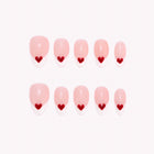 Queen of Hearts French: pink almond press-on nails with white French tips and small red hearts, arranged on a pale background.
