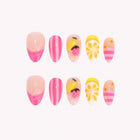 Midsummer Citrus Dream: pink and yellow press-on nails with stripes, strawberries and citrus slices, arranged on a pale background.