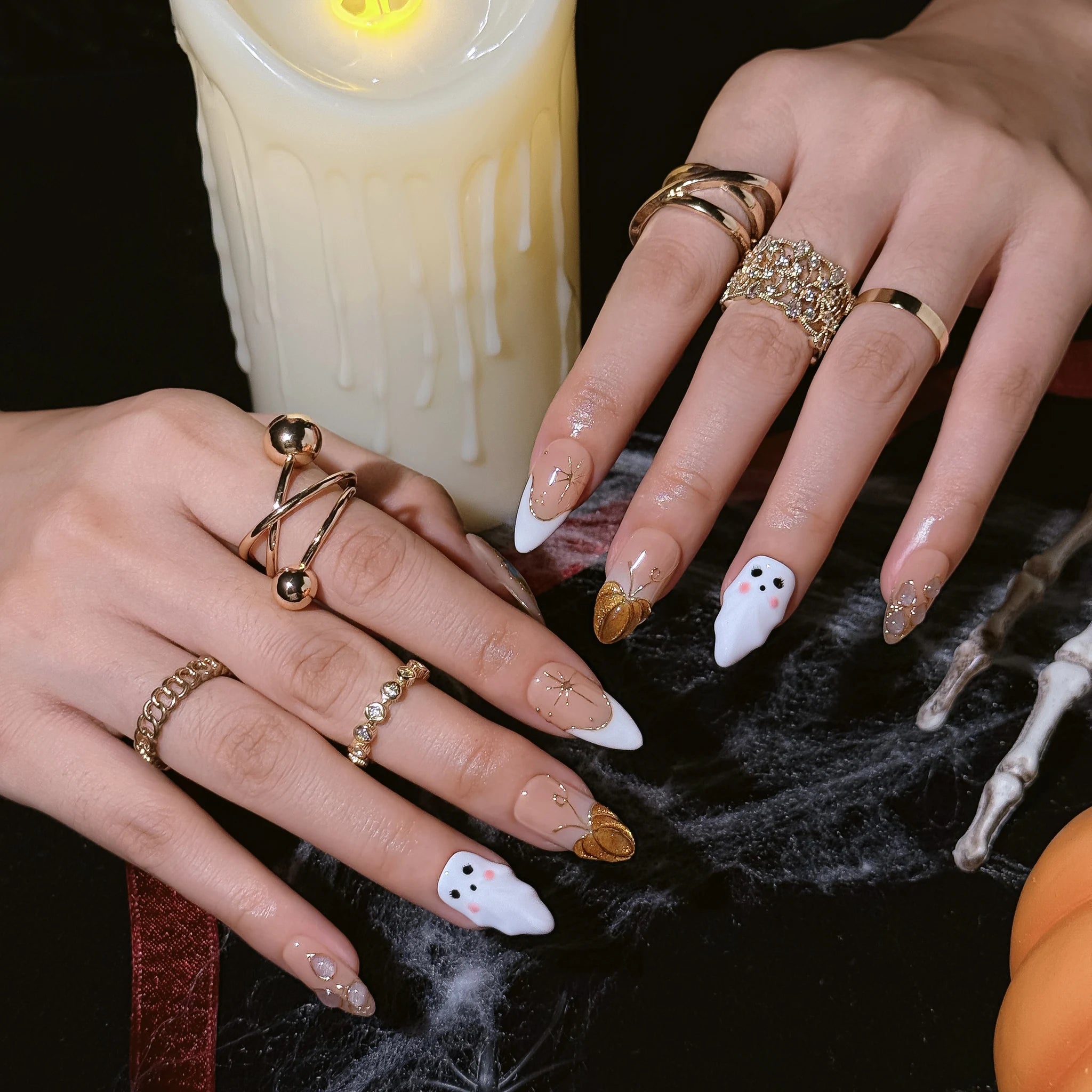 Amber Ghost Lantern press-on nails worn on both hands in a styled lifestyle setting