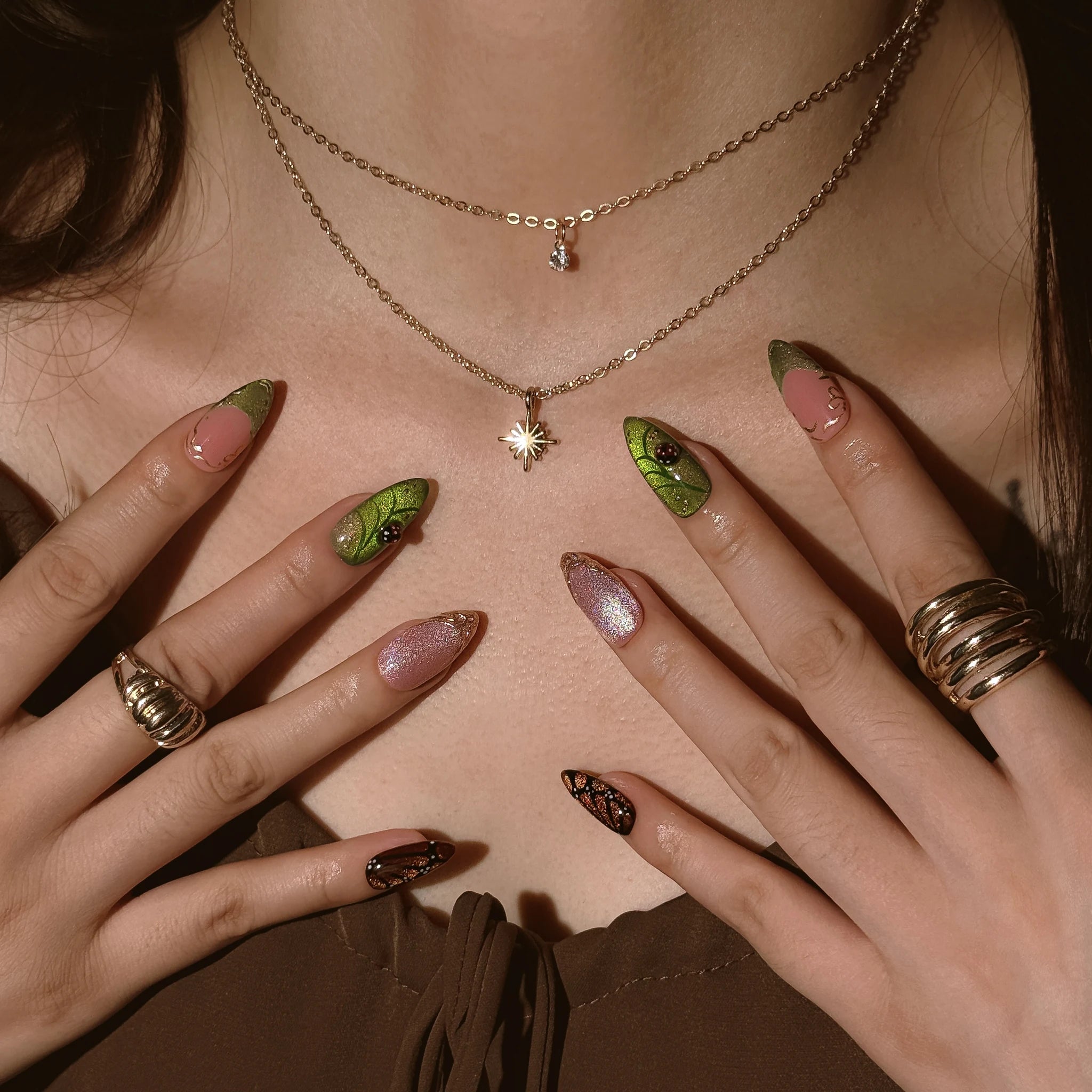 Monarch Meadow Magic press-on nails worn on both hands in a styled lifestyle setting