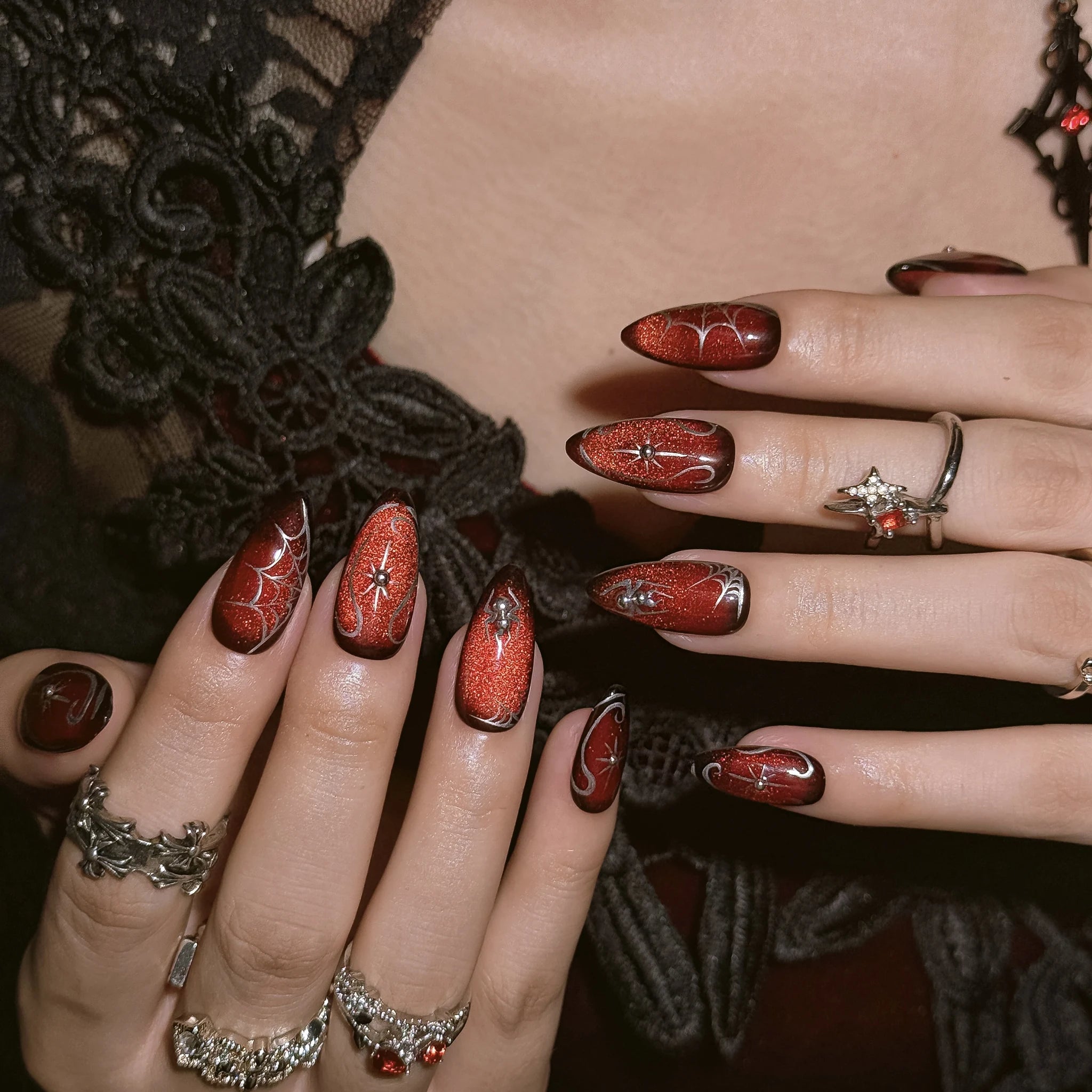 Ruby Web Enchantment press-on nails worn on both hands in a styled lifestyle setting