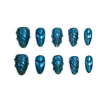 Celestial Tide: teal-blue metallic press-on nails with raised hearts and shell-like ridges, arranged on a pale background.