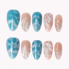 Azure Shell Tide press-on nails in blue, nude, and silver with shell texture, glitter, and pearl-like details