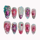 Aurora Bow Reverie press-on nails in pink, aqua, nude, and silver with 3D bows, pearl details, crystals, and chrome shine