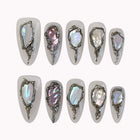 Moonlit Opal Relic press-on nails in ivory and silver with chrome frames, opal-like inlays, and raised 3D details