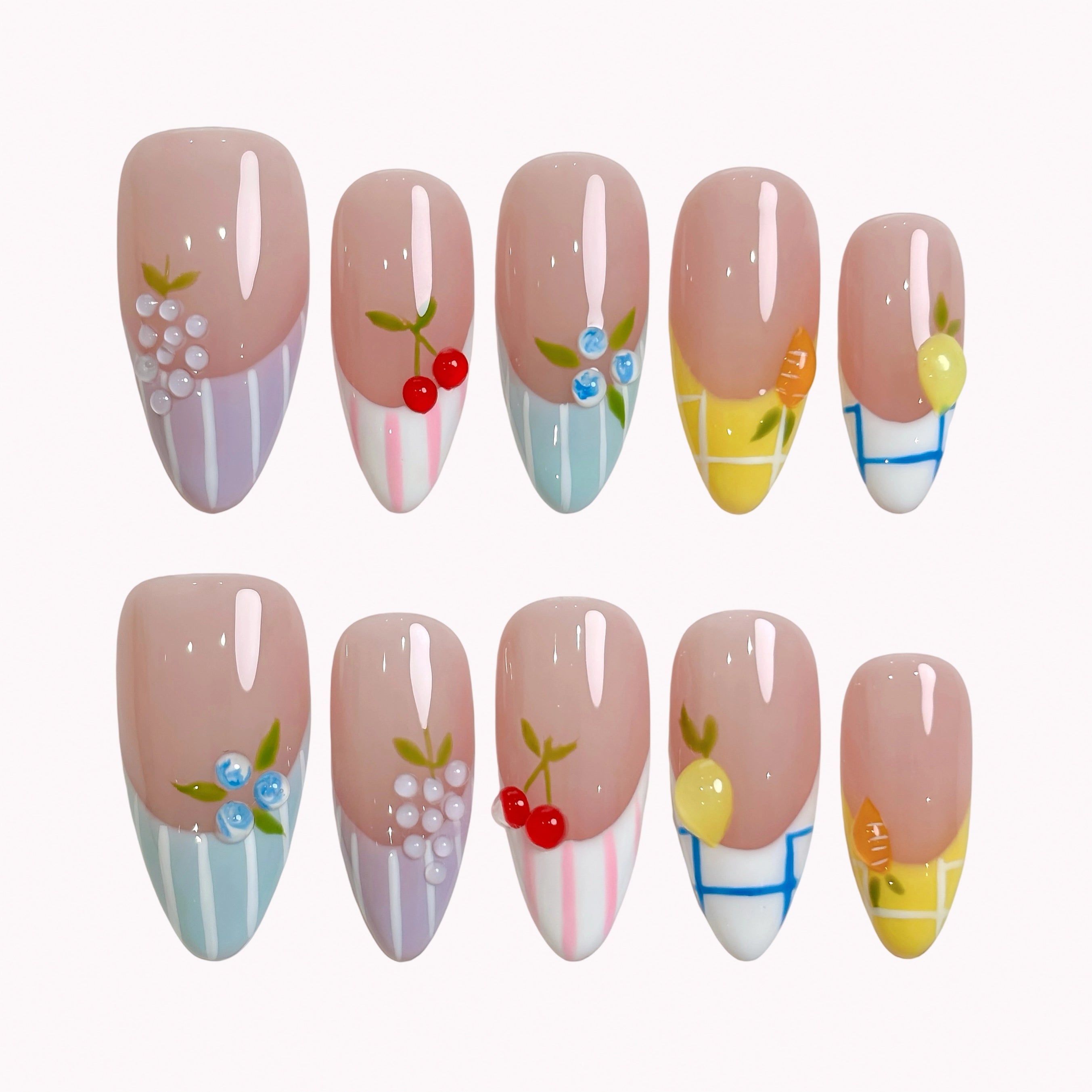 Pastel Orchard Reverie press-on nails in nude, blue, yellow, lavender, and white with 3D fruit details