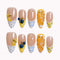 Citrus Picnic Reverie press-on nails in nude, yellow, blue, orange, and white with citrus slices, blueberries, and polka dots