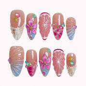 Coral Citrus Cove press-on nails in pink, blue, orange, and nude with citrus slices, shells, flowers, starfish, and crystals