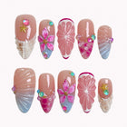 Coral Citrus Cove press-on nails in pink, blue, orange, and nude with citrus slices, shells, flowers, starfish, and crystals