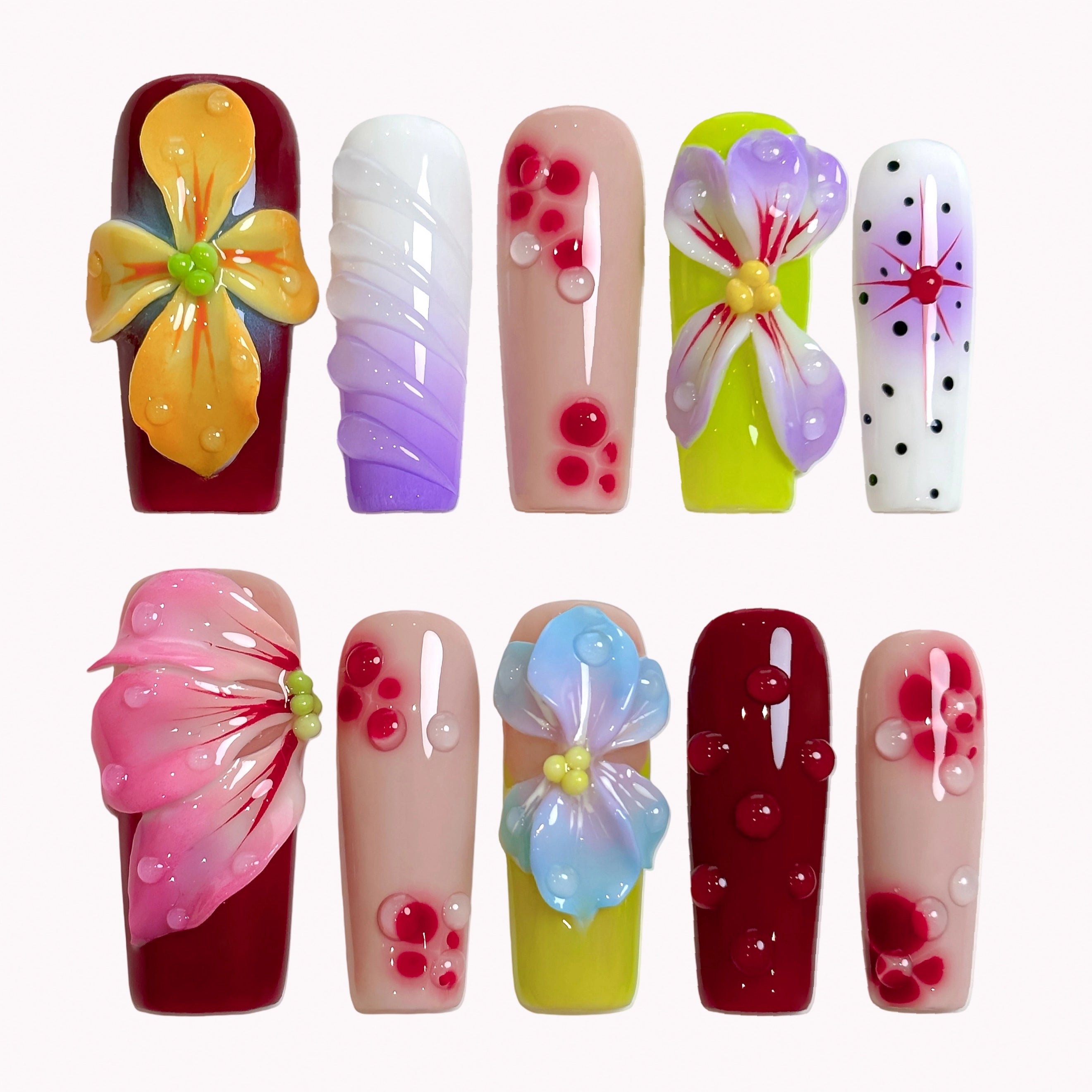 Carnival Bloom Reverie press-on nails in red, green, pink, yellow, purple, blue, nude, and white with 3D flowers, polka dots, and glossy details
