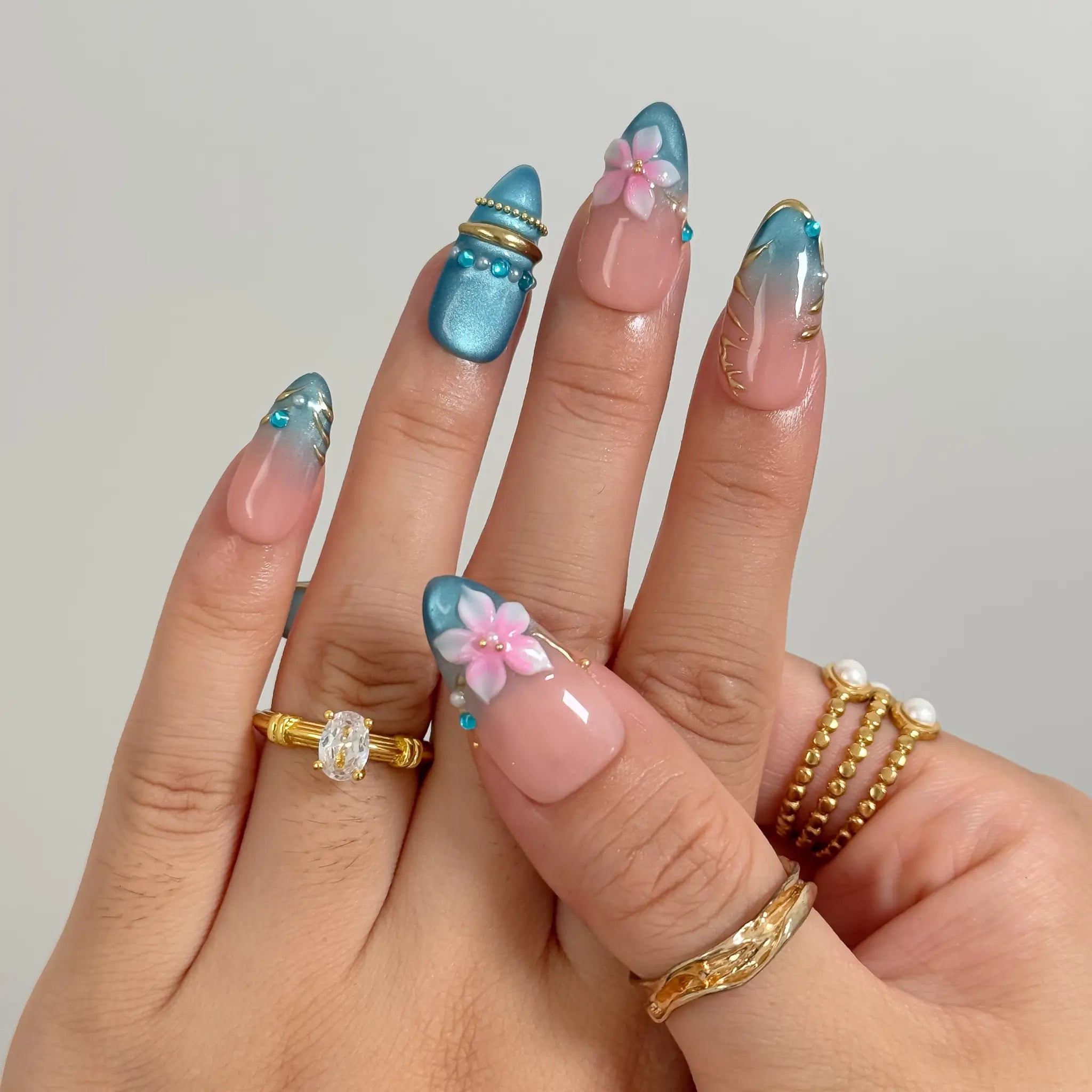 Lagoon Petal Treasure press-on nails in Blue, Pink, Gold, Nude, detail view 1