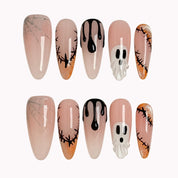 Spooky Stitch Specter press-on nails in Nude, Black, Orange, White on a white background