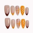 Amber Dot Whimsy press-on nails in Nude, Orange, Brown on a white background