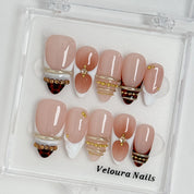 Gilded Tortoise Frame press-on nail set arranged in a Veloura Nails display case
