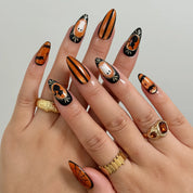 Midnight Pumpkin Portrait Long Almond press-on nails, modeled detail view 1