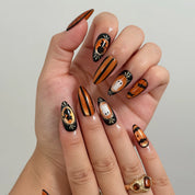 Midnight Pumpkin Portrait Long Almond press-on nails, modeled detail view 2