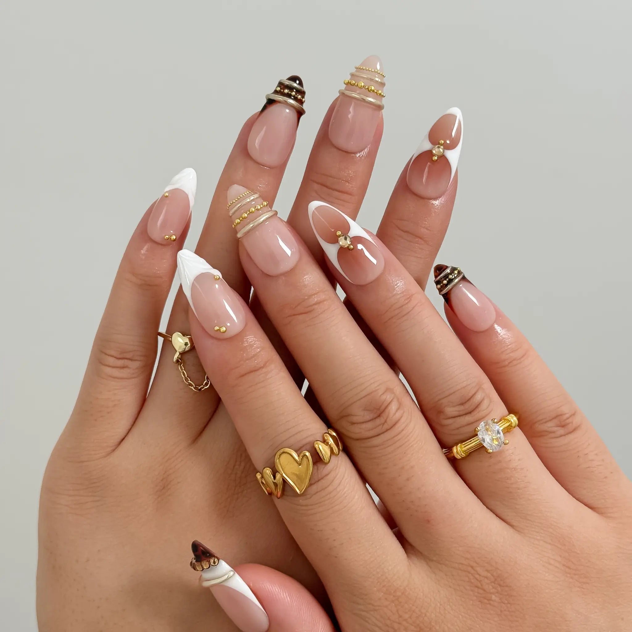 Gilded Tortoise Frame Long Almond press-on nails, modeled detail view 1
