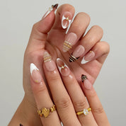 Gilded Tortoise Frame Long Almond press-on nails, modeled detail view 2