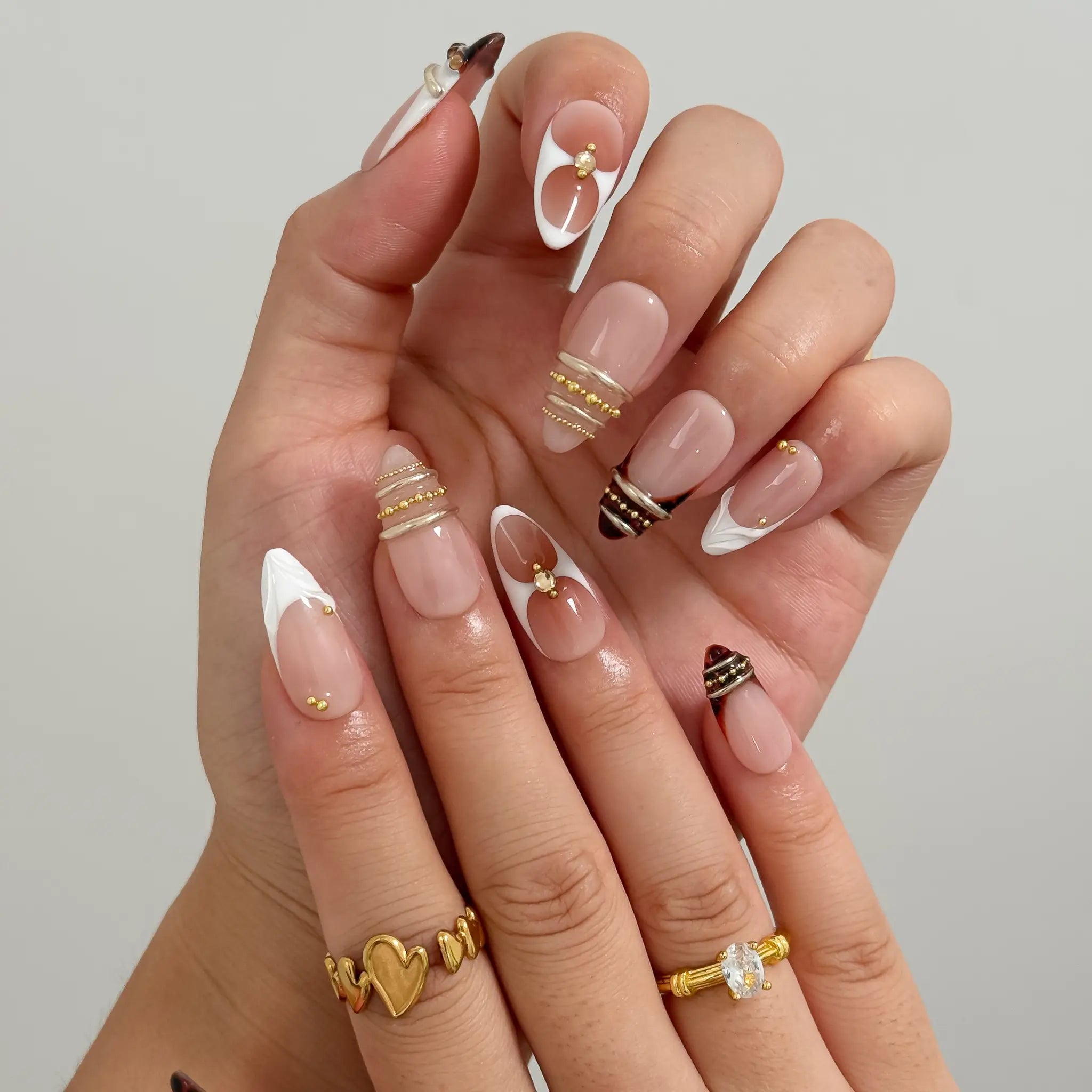 Gilded Tortoise Frame Long Almond press-on nails, modeled detail view 2