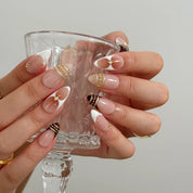 Gilded Tortoise Frame Long Almond press-on nails, modeled detail view 3