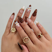 Mocha Blossom Lace Long Almond press-on nails, modeled detail view 1