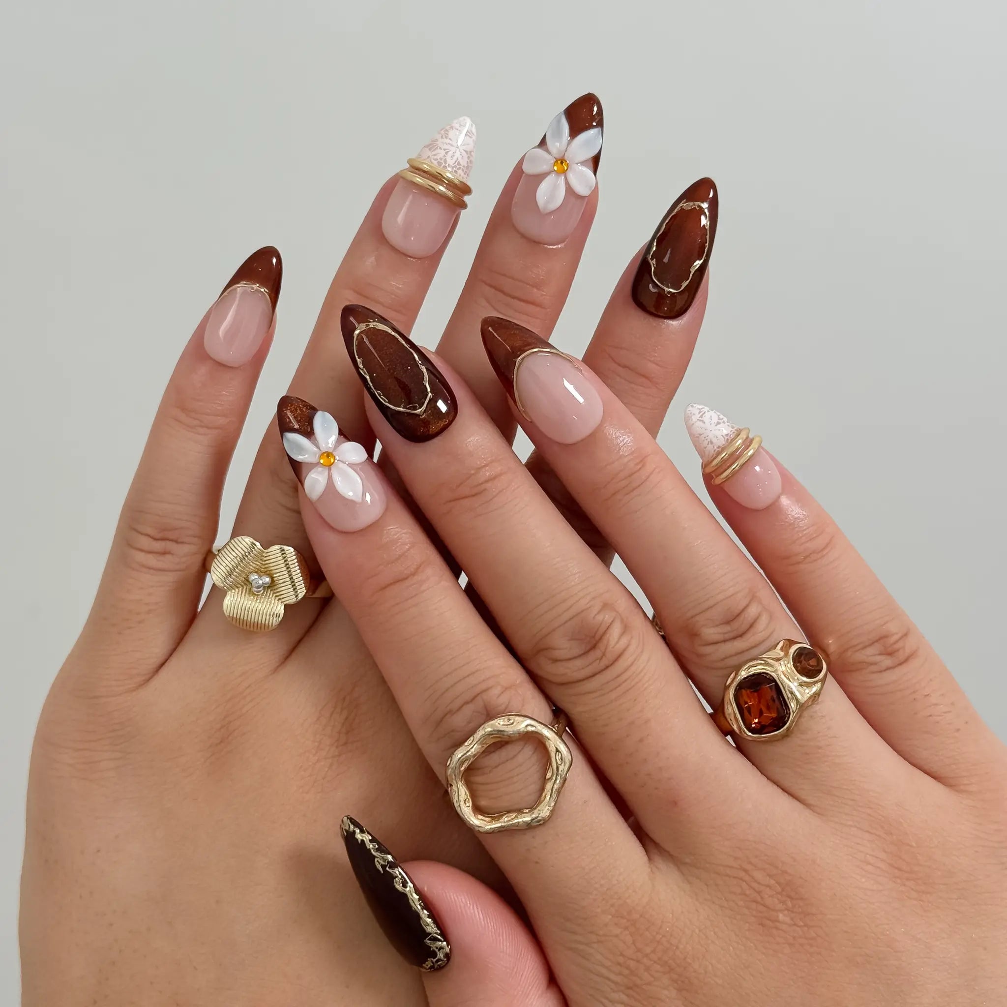Mocha Blossom Lace Long Almond press-on nails, modeled detail view 1