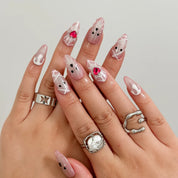 Blushing Phantom Heart Long Almond press-on nails, modeled detail view 1