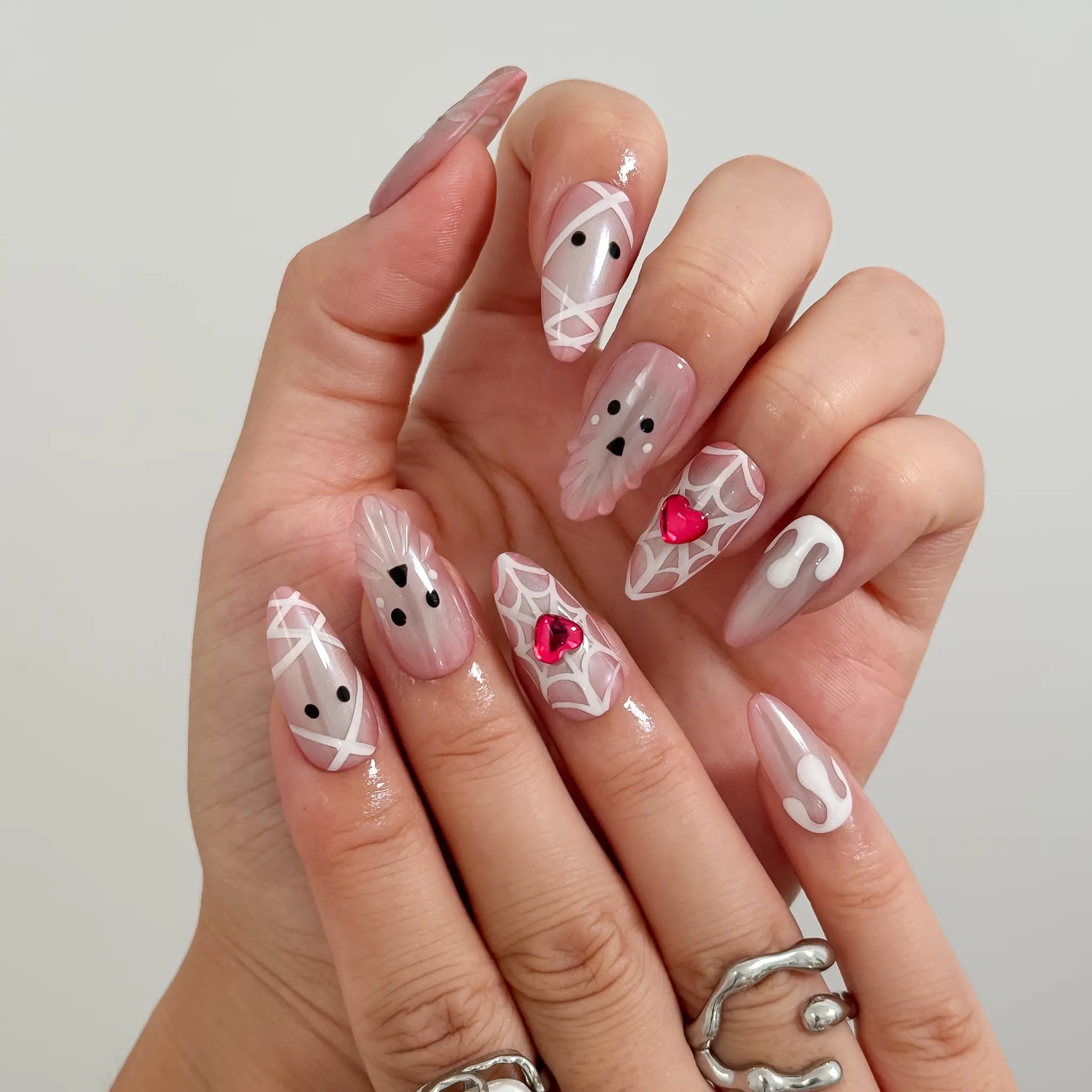 Blushing Phantom Heart Long Almond press-on nails, modeled detail view 2