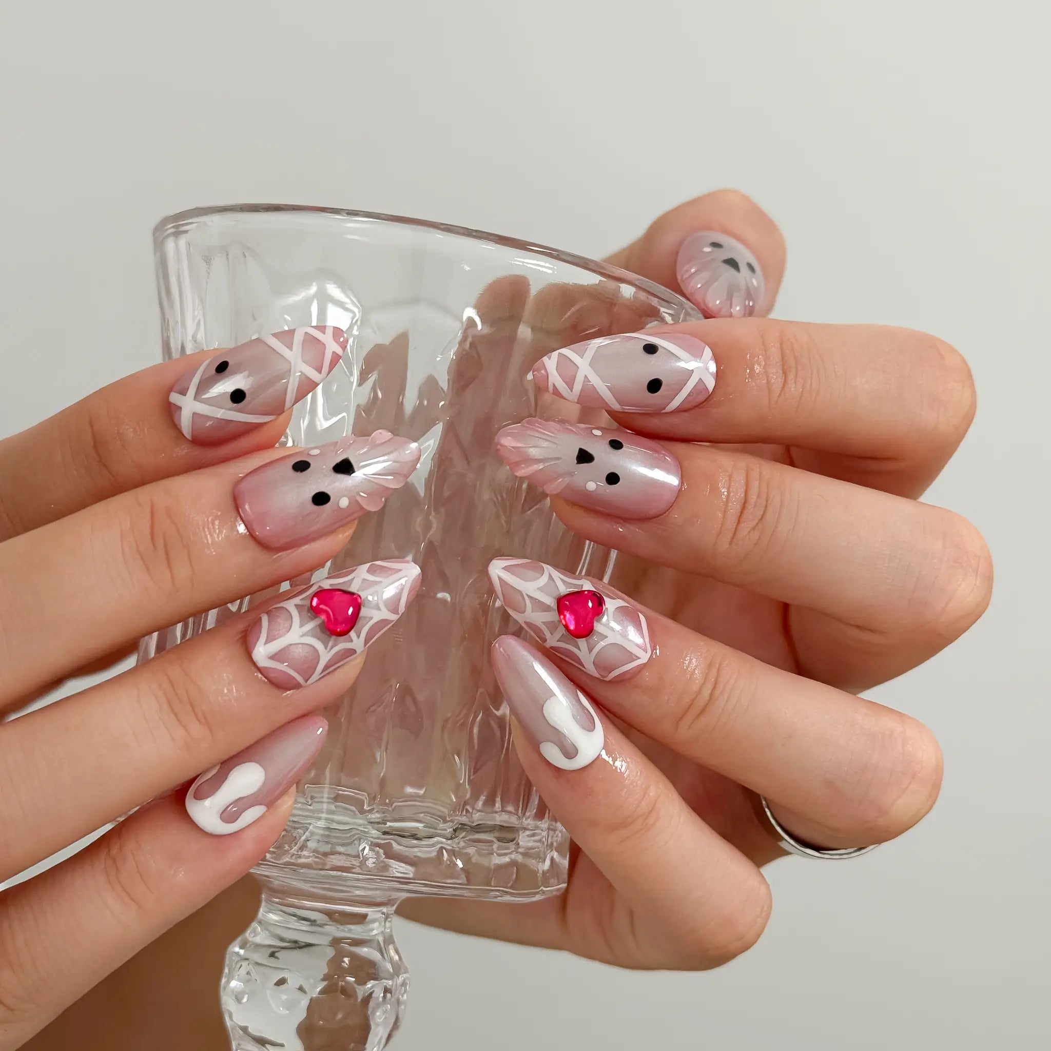 Blushing Phantom Heart Long Almond press-on nails, modeled detail view 3