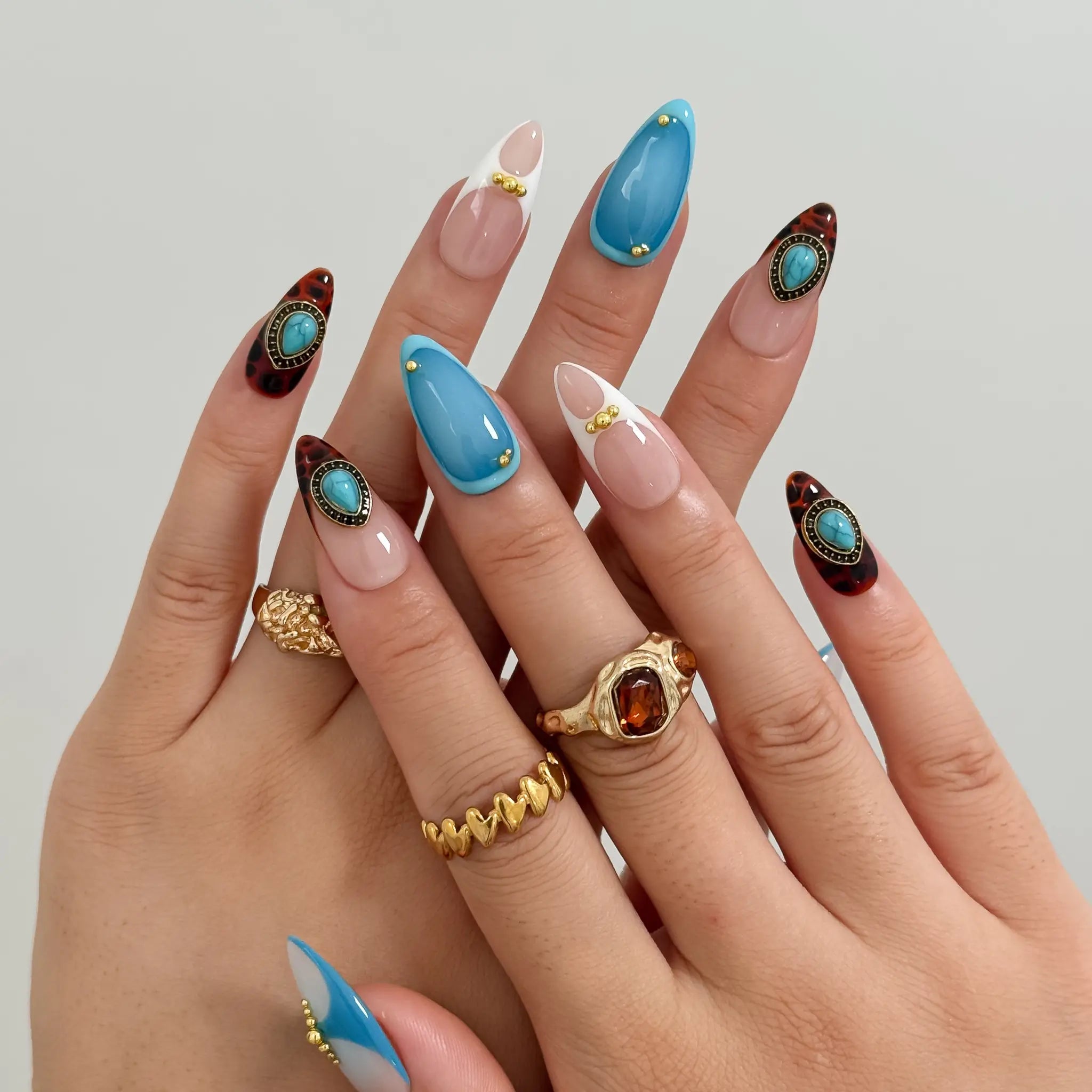 Turquoise Talisman Long Almond press-on nails, modeled detail view 1