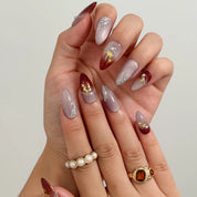 Burgundy Foil Reverie Long Almond press-on nails, modeled detail view 2