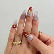 Burgundy Foil Reverie Long Almond press-on nails, modeled detail view 3