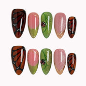Monarch Meadow Magic press-on nails in Brown, Black, Green, Pink, Gold on a white background