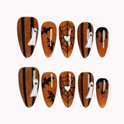 Haunted Amber Web press-on nails in Orange, Black, White on a white background
