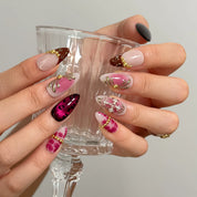 Crimson Rosary Bloom Long Almond press-on nails, modeled detail view 2