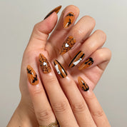 Haunted Amber Web Long Stiletto press-on nails, modeled detail view 1