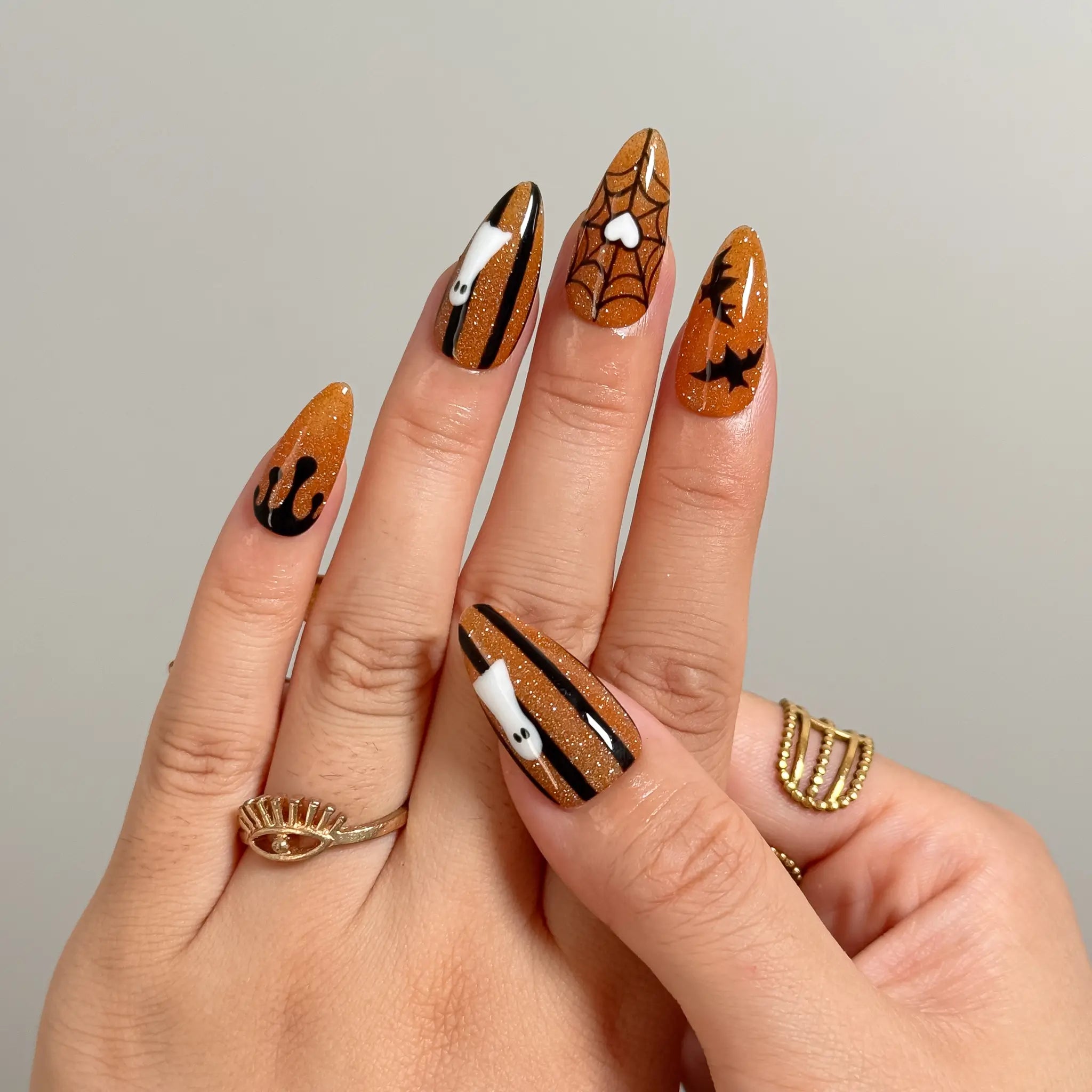 Haunted Amber Web Long Stiletto press-on nails, modeled detail view 2