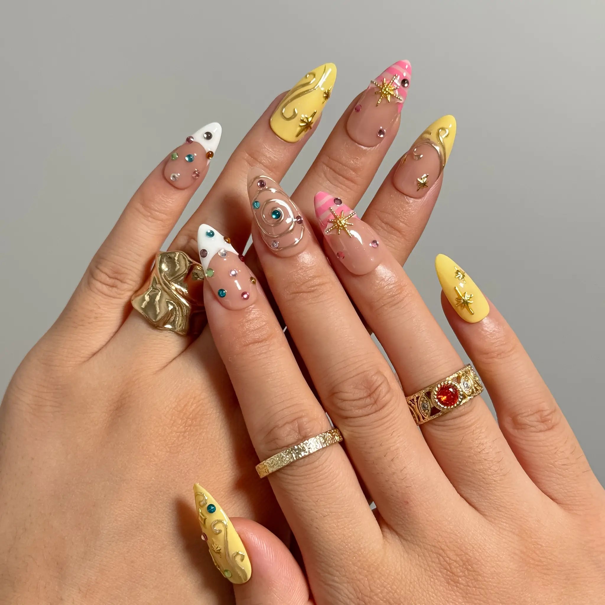 Candy Orbit Charms Long Almond press-on nails, modeled detail view 1