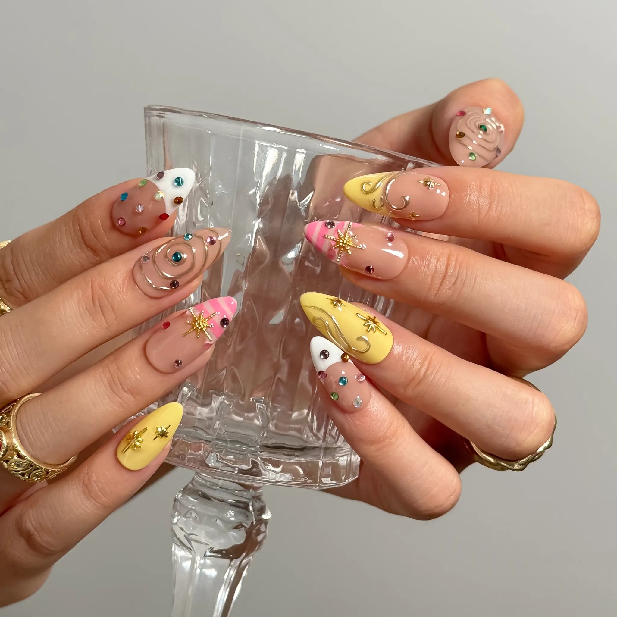 Candy Orbit Charms Long Almond press-on nails, modeled detail view 2